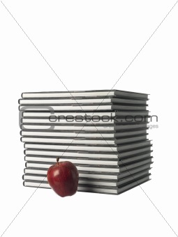 Pile of books and an apple