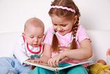 Adorable kids reading and playing