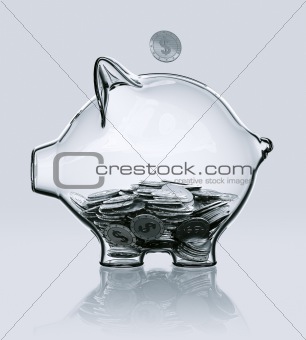 Piggy bank in glass filled with coins