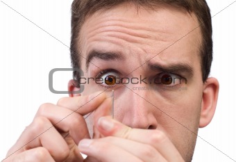 Man Threading A Needle