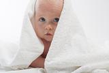 Curious baby covered with towel