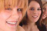 three female teens smiling