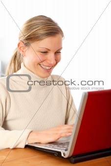 happy female working on her laptop