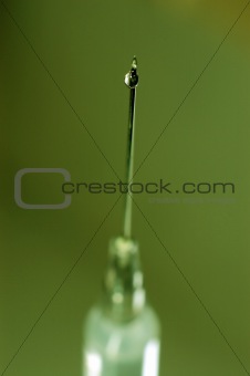 syringe close-up, focus on the drop