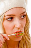 portrait of smiling female licking candy