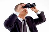 young executive observing through binoculars