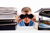 man with binocular searching and look between books