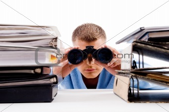man with binocular searching and look between books