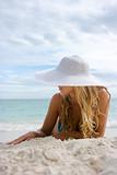 Blonde in white hat on the beach