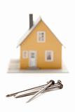 House and Nails Isolated on a White Background.
