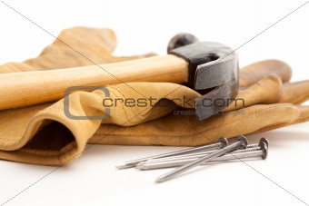 Hammer, Gloves and Nails Isolated on a White Background.