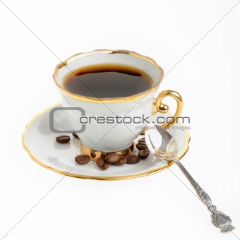 stylish coffee cup with silver spoon and seed