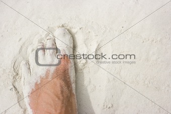Foot on white sand