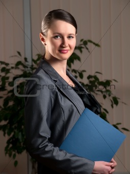 Young attractive business woman with folder