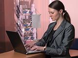 Attractive business woman is typing on laptop keyboard
