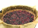 Delicious berry cake in baking pan with baking paper