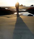 Man casts shadow on the beach
