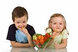 Happy kids eating vegetables