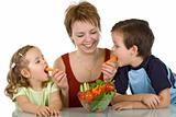 Happy kids eating vegetables
