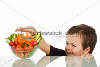 Happy boy stealing vegetables
