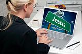 Woman In Kitchen Using Laptop with Jesus Road Sign on Screen. Screen can be easily used for your own message or picture. Picture on screen is my copyright as well.