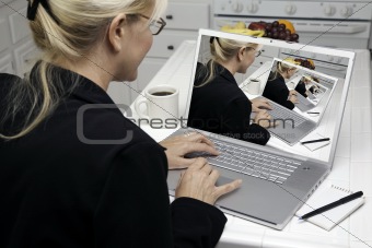 Abstract of Woman In Kitchen Using Laptop. Screen can be easily used for your own message or picture. Picture on screen is my copyright as well.