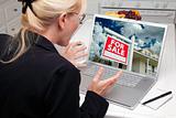 Excited Woman In Kitchen Using Laptop to Buy a Home. Screen can be easily used for your own message or picture. Picture on screen is my copyright as well.