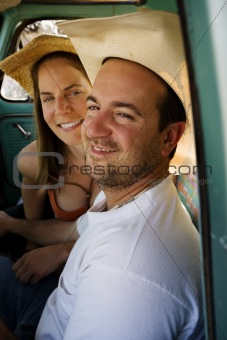 Cowboy and woman in pickup truck