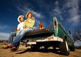 Cowboy and woman on pickup truck