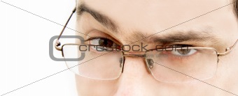 close up of young man in glasses looking in camera 