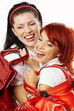 two young smiling women with red handbags
