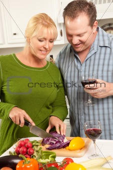 Happy Couple Enjoying An Evening Preparing Food in the Kitchen.