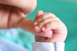 Baby's hand gripping for mothers finger