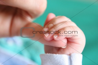 Baby's hand gripping for mothers finger