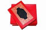 Red cover book with golden ornament in red cardboard box.