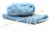 Two knitting needles, woollen yarn clew and knitting cloth.
