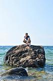 Man stranded on a rock in ocean