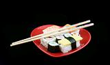 Sushi on a Black Background with chopsticks