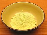 Cornmeal  in a bowl of ceramic on an orange background
