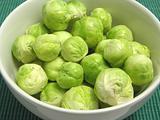 Brussels sprouts in a white bowl and green placemat