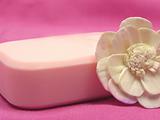 Pink soap with decoration articles on a  pink background