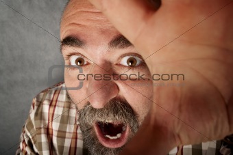 Closeup of man in his 40s screaming