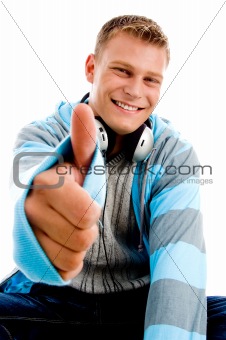 young happy male with headphones and thumbs up