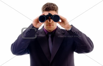 handsome young businessman looking through binoculars