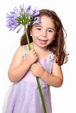 Little girl holding large african lily - agapanthus