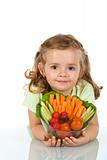 Little girl holding a bowl of vegetables