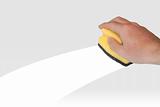 Hand with yellow sponge isolated on grey background and white clean track