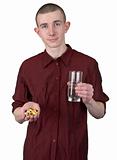 Young man with glass of water and tablets