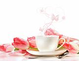 Tea cup with pink tulips on white 