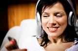  women listening music in headphones